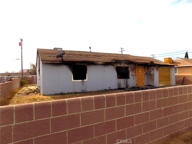 1918 Barstow Rd, Mojave, CA 93501 - view of front of house with an attached garage, a fenced backyard, and stucco siding