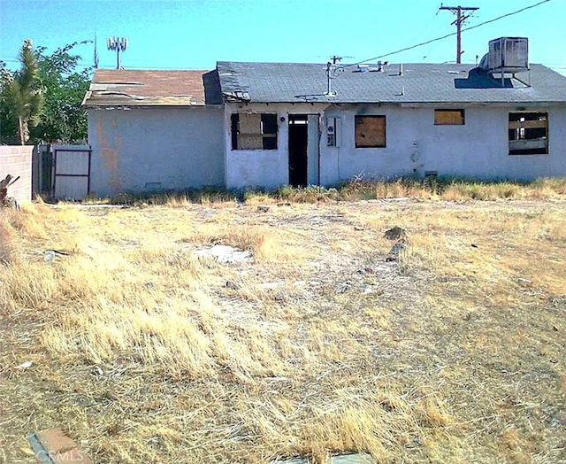 1918 Barstow Rd, Mojave, CA 93501 - back of property with stucco siding and central AC unit