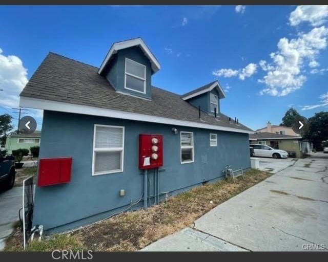 15122 Eastwood Ave, Lawndale, CA 90260 - view of property exterior featuring stucco siding and roof with shingles