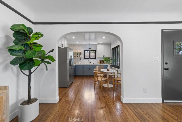 3556 Olive Ave, Long Beach, CA 90807 - dining space with dark wood-type flooring, baseboards, arched walkways, and recessed lighting
