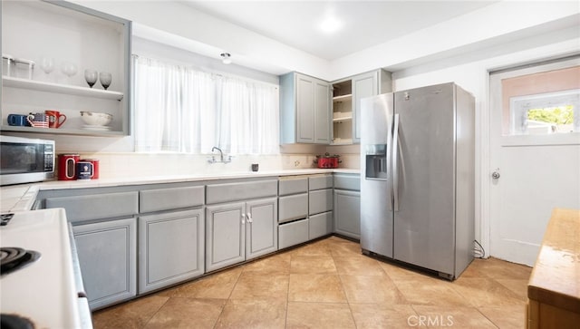 529 E Harvard Pl, Ontario, CA 91764 - kitchen with stainless steel appliances, gray cabinetry, open shelves, a sink, and light tile patterned floors