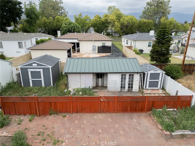 529 E Harvard Pl, Ontario, CA 91764 - rear view of house with a standing seam roof, a fenced backyard, metal roof, french doors, and a residential view