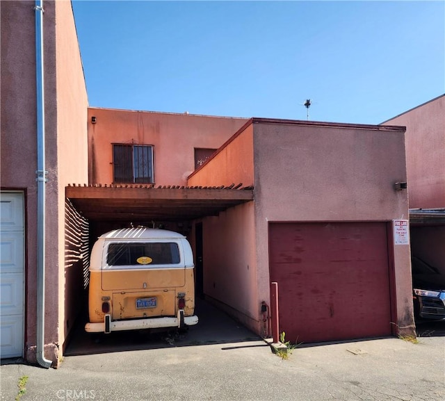 411 N Brannick Unit B, Los Angeles, CA 90063 - view of front of home featuring stucco siding, driveway, and an attached garage