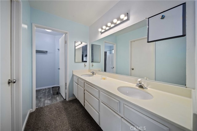 43816 Fallon Dr, Lancaster, CA 93535 - full bathroom featuring double vanity, baseboards, and a spacious closet