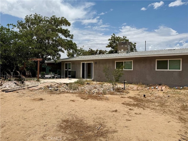 18083 Deodar St, Hesperia, CA 92345 - rear view of house with stucco siding and a patio
