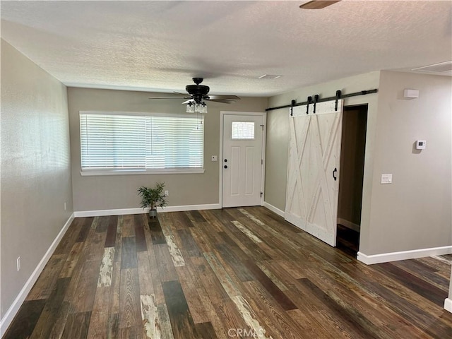 18083 Deodar St, Hesperia, CA 92345 - foyer with a ceiling fan, a barn door, wood finished floors, and a textured ceiling