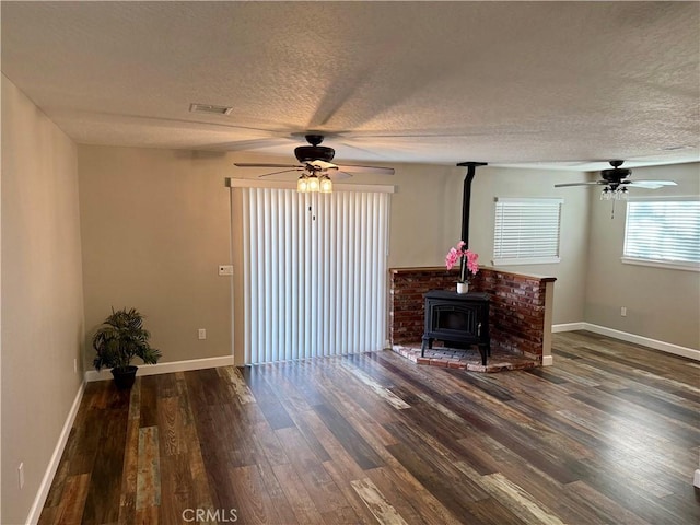 18083 Deodar St, Hesperia, CA 92345 - living area featuring a ceiling fan, wood finished floors, a wood stove, and a textured ceiling