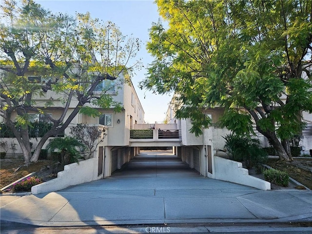 21409 Bloomfield Ave Unit C, Lakewood, CA 90715 - view of side of home featuring stucco siding, a carport, and driveway