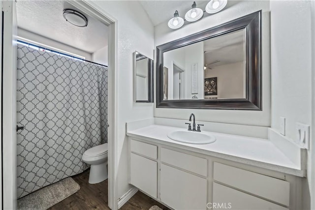 13883 Northstar Ave, Victorville, CA 92392 - full bathroom with wood finished floors, vanity, a textured ceiling, a shower with curtain, and ceiling fan