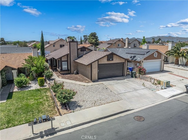 13883 Northstar Ave, Victorville, CA 92392 - view of front of property with a residential view, concrete driveway, an attached garage, and a front lawn