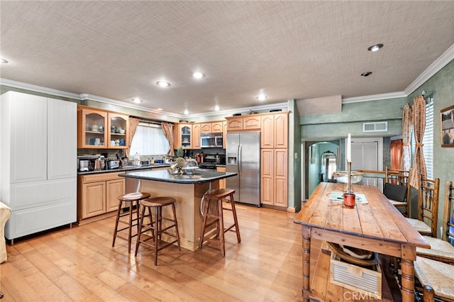 1623 W Balboa Blvd, Newport Beach, CA 92663 - kitchen with appliances with stainless steel finishes, crown molding, light wood finished floors, a kitchen bar, and glass insert cabinets