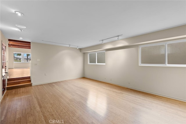 1623 W Balboa Blvd, Newport Beach, CA 92663 - spare room featuring rail lighting, wood finished floors, and baseboards