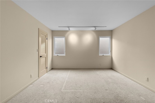 1623 W Balboa Blvd, Newport Beach, CA 92663 - empty room with carpet, plenty of natural light, track lighting, and baseboards
