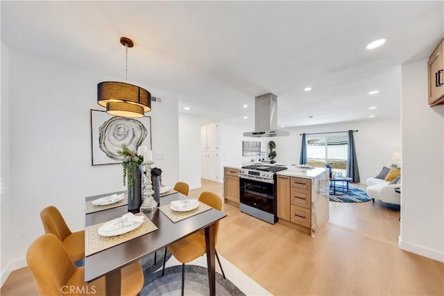 144 N Dommer Ave, Walnut, CA 91789 - kitchen featuring gas range, range hood, light wood-style floors, light countertops, and recessed lighting