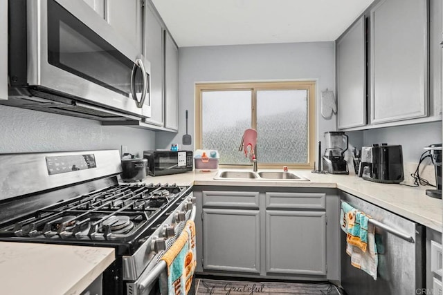 1380 E Washington Ave Unit 2, El Cajon, CA 92019 - kitchen with appliances with stainless steel finishes, a sink, gray cabinets, and light countertops