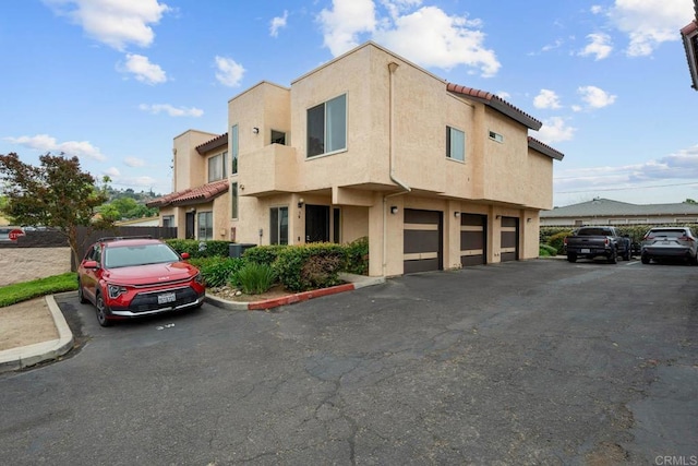 1380 E Washington Ave Unit 2, El Cajon, CA 92019 - view of front facade with stucco siding, a garage, and central AC unit