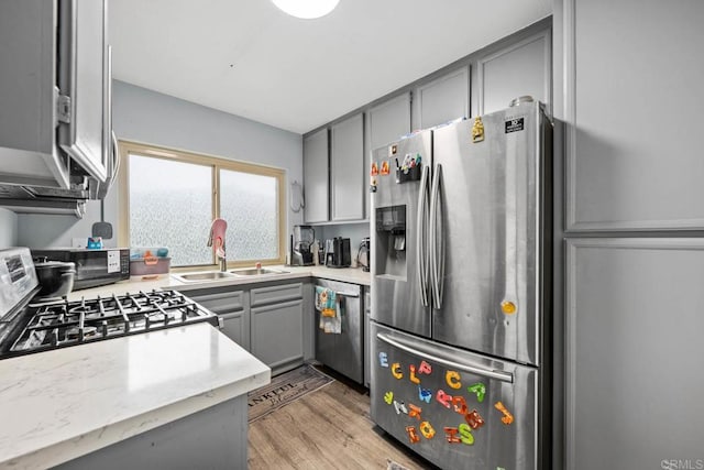 1380 E Washington Ave Unit 2, El Cajon, CA 92019 - kitchen with appliances with stainless steel finishes, gray cabinetry, a sink, and light wood-style flooring