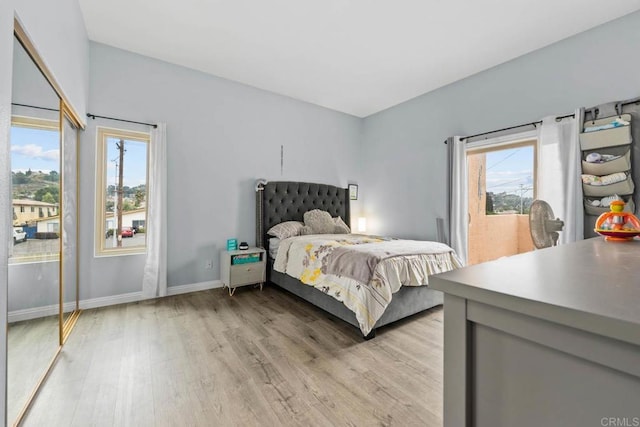 1380 E Washington Ave Unit 2, El Cajon, CA 92019 - bedroom with light wood finished floors, baseboards, and access to exterior