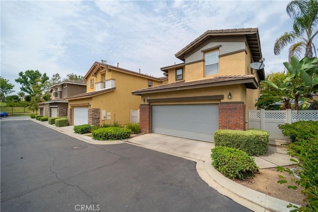 1803 Chambers Ct, Fullerton, CA 92833 - multi unit property featuring an attached garage, stucco siding, asphalt driveway, and brick siding
