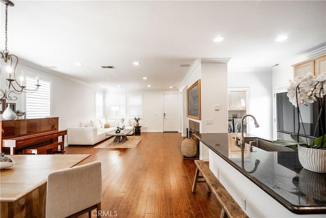 1803 Chambers Ct, Fullerton, CA 92833 - living area featuring separate washer and dryer, recessed lighting, crown molding, a chandelier, and dark wood-type flooring