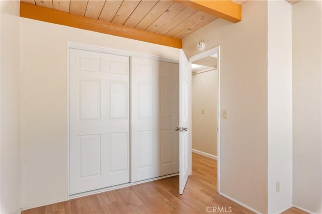 3996 Leonore Ave, Clearlake, CA 95422 - unfurnished bedroom with wooden ceiling, light wood-type flooring, a closet, and baseboards