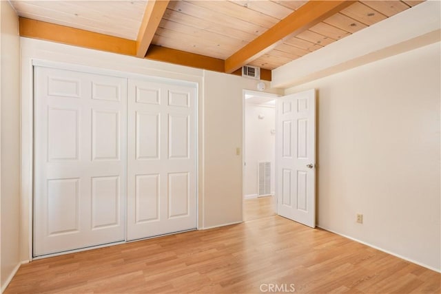 3996 Leonore Ave, Clearlake, CA 95422 - unfurnished bedroom featuring light wood-style flooring, wooden ceiling with exposed beams, a closet, and baseboards
