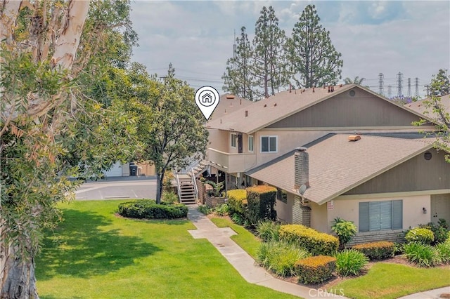 338 E Palmdale Ave Unit 4, Orange, CA 92865 - back of property featuring a yard, stairs, and stucco siding