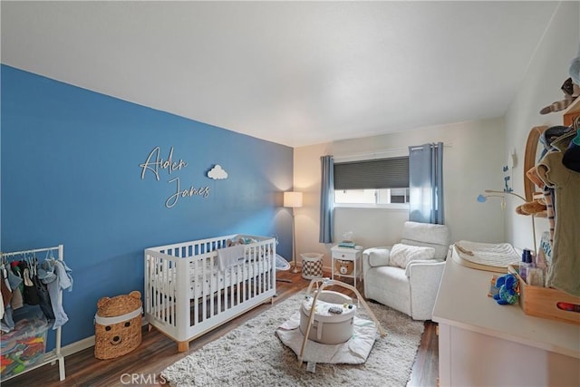 338 E Palmdale Ave Unit 4, Orange, CA 92865 - bedroom featuring wood finished floors and a crib
