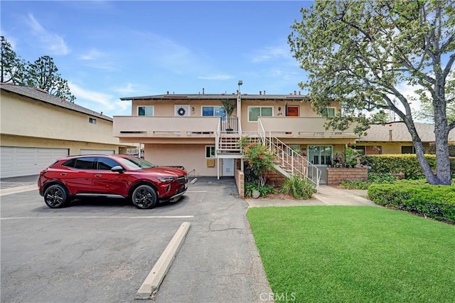 338 E Palmdale Ave Unit 4, Orange, CA 92865 - view of property with stairs, stucco siding, and a front lawn