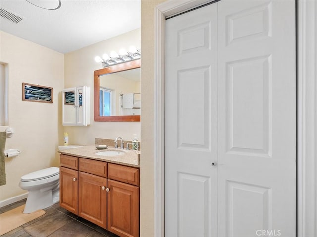 49333 Riverside Rd, Newberry Springs, CA 92365 - bathroom with a closet, vanity, toilet, and baseboards