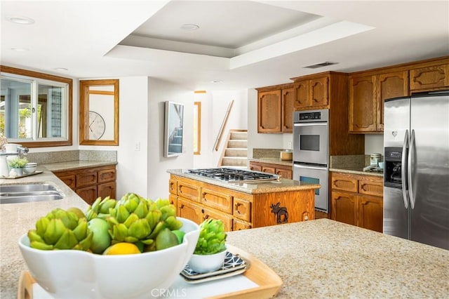 32022 Via Pavo Real, Coto De Caza, CA 92679 - kitchen with stainless steel appliances, a tray ceiling, brown cabinetry, and recessed lighting