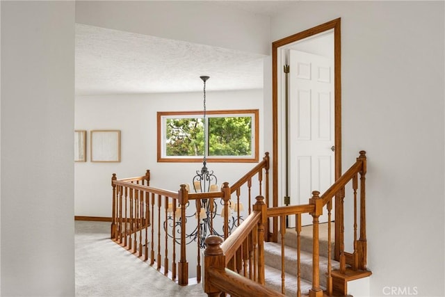 32022 Via Pavo Real, Coto De Caza, CA 92679 - stairway with a chandelier, carpet flooring, baseboards, and a textured ceiling