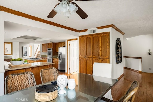32022 Via Pavo Real, Coto De Caza, CA 92679 - dining room with ceiling fan, a raised ceiling, dark wood finished floors, stairway, and baseboards