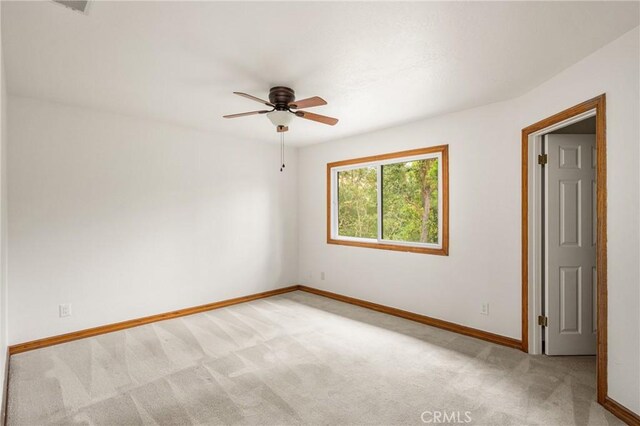 32022 Via Pavo Real, Coto De Caza, CA 92679 - spare room featuring light colored carpet, baseboards, and ceiling fan