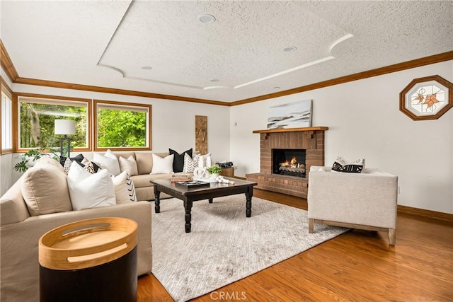 32022 Via Pavo Real, Coto De Caza, CA 92679 - living room with a textured ceiling, a brick fireplace, wood finished floors, crown molding, and baseboards