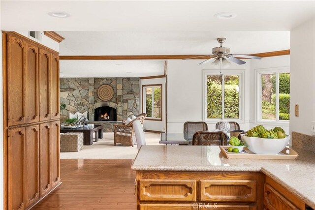 32022 Via Pavo Real, Coto De Caza, CA 92679 - kitchen featuring ceiling fan, a fireplace, plenty of natural light, and hardwood / wood-style flooring