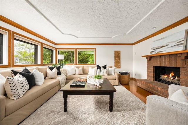 32022 Via Pavo Real, Coto De Caza, CA 92679 - living room with wood finished floors, a fireplace, crown molding, and a textured ceiling