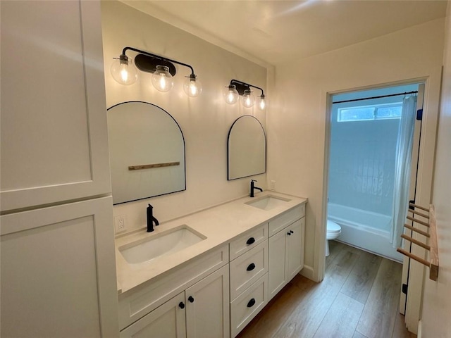 3972 Jackdaw St Unit 303, San Diego, CA 92103 - bathroom featuring toilet, double vanity, wood finished floors, and shower / bath combination