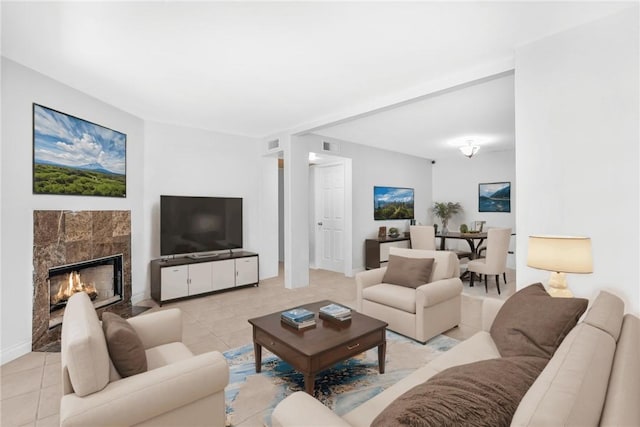 8321 Vineyard Ave Unit U5, Rancho Cucamonga, CA 91730 - living room featuring light tile patterned flooring, a tiled fireplace, and baseboards