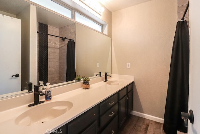 1330 Santa Fe Cir, Needles, CA 92363 - bathroom with wood finished floors, double vanity, baseboards, and a tile shower