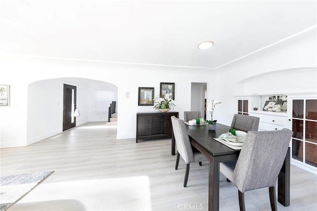 615 S Victoria Ave, Corona, CA 92879 - dining room featuring arched walkways, light wood-type flooring, and baseboards