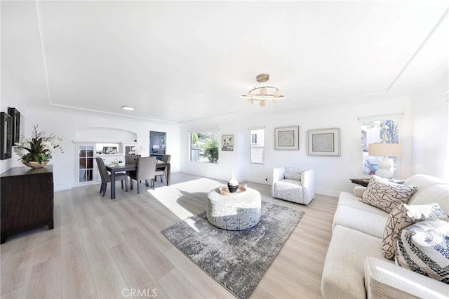 615 S Victoria Ave, Corona, CA 92879 - living room with light wood-type flooring, arched walkways, baseboards, a chandelier, and recessed lighting