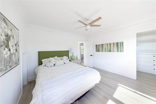 615 S Victoria Ave, Corona, CA 92879 - bedroom with light wood-type flooring, ceiling fan, baseboards, and a walk in closet
