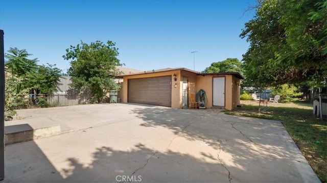 1373 W 5th St, San Bernardino, CA 92411 - view of front of property featuring stucco siding, an attached garage, and driveway