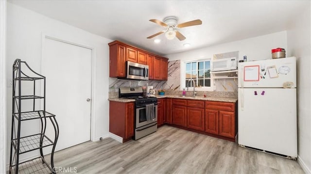 1373 W 5th St, San Bernardino, CA 92411 - kitchen with stainless steel appliances, a sink, a ceiling fan, light wood-style flooring, and tasteful backsplash