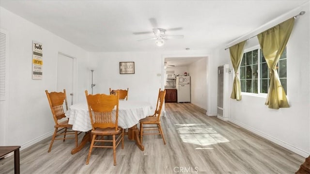 1373 W 5th St, San Bernardino, CA 92411 - dining area with a ceiling fan, wood finished floors, baseboards, and a heating unit