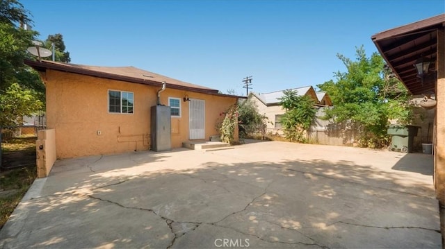 1373 W 5th St, San Bernardino, CA 92411 - back of property with stucco siding and a patio area