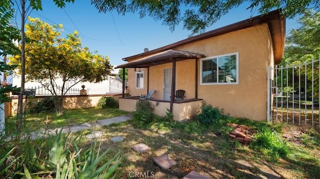 1373 W 5th St, San Bernardino, CA 92411 - bungalow-style house featuring stucco siding