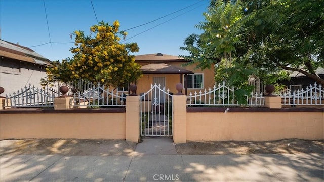1373 W 5th St, San Bernardino, CA 92411 - view of front facade featuring a fenced front yard, a gate, and stucco siding