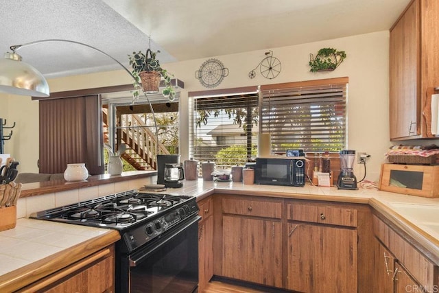 150 Richeth Rd, San Diego, CA 92114 - kitchen featuring black appliances, tile counters, and brown cabinets